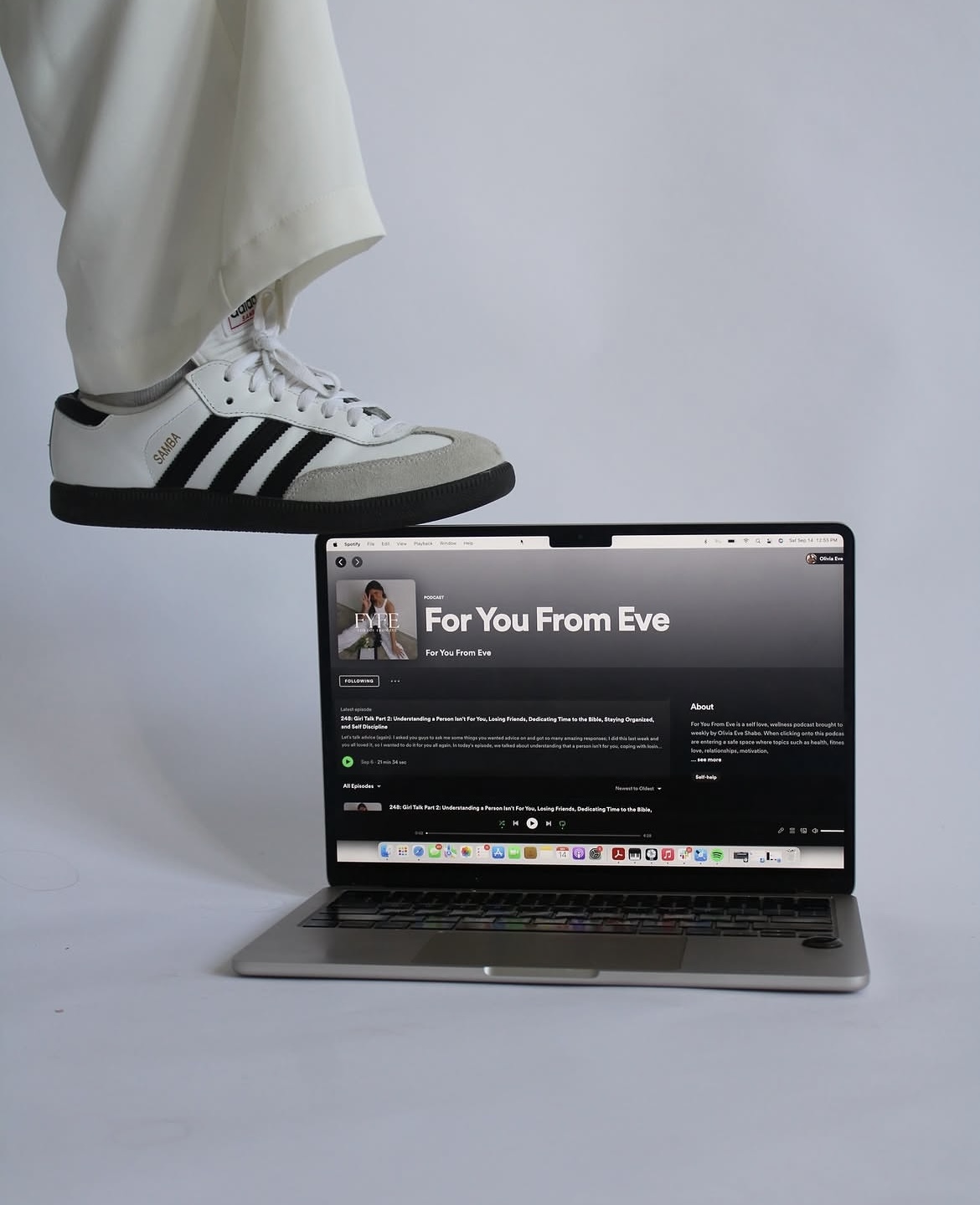 Sneaker poised above a laptop displaying the For You From Eve podcast page
