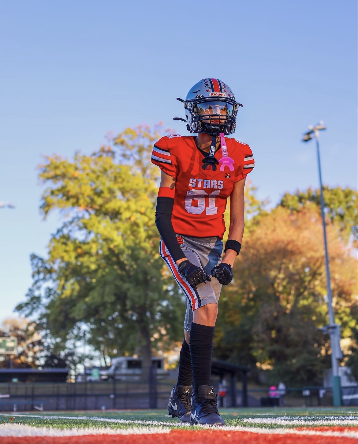 Stars number 81 standing tall on the field in full football uniform