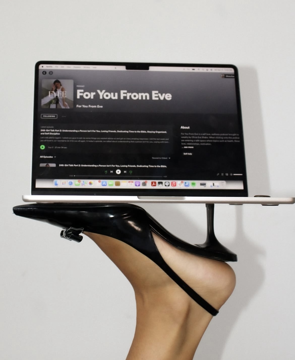 Laptop balanced on a black heel in a bold editorial branding image