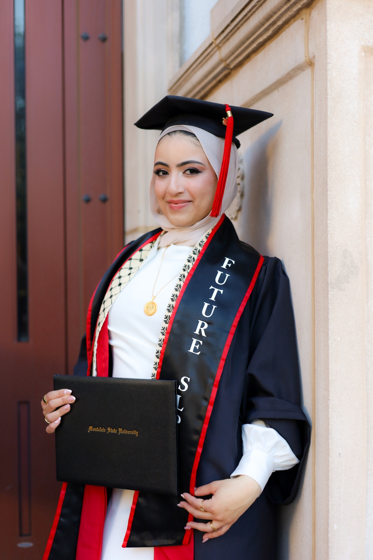 Montclair State University graduate holding diploma
