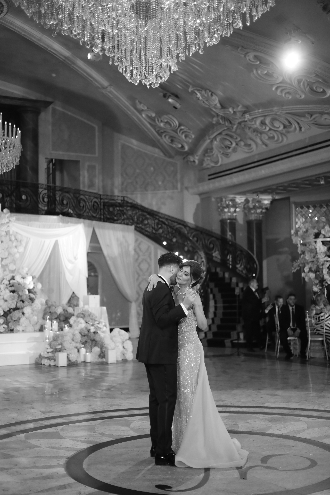 Black and white photo of a mother and son sharing a dance in the grand ballroom