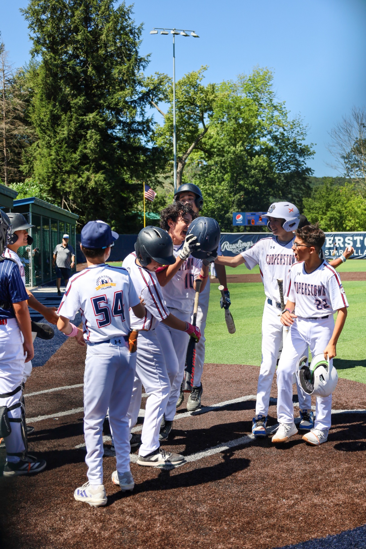 Cooperstown baseball team celebrating a home run at the plate