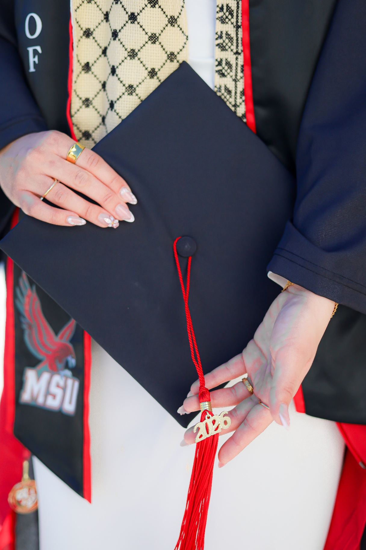 Close-up of MSU graduation cap, stole, and tassel